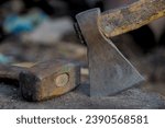 Small photo of Sledgehammer and ax on wooden base close-up