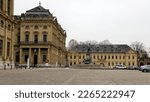 Small photo of Wurzburg, Germany - January 26, 2023: Residenzplatz, cobblestone square in front of the Archbishopric Palace, gloomy afternoon view
