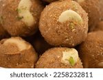 Small photo of Indian Mithai Gud Churma Ke Laddu Or Choorma Ke Ladoo Is Made Of Whole Wheat Jada Gehun Ka Atta, Khus Khus, Gur, Jaggery, Kaju, Badam, Dry Fruits Roasted In Desi Ghee Or Clarified Butter