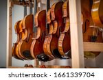 Racks Of Violins Hanging In A...