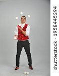 A male juggler in a dracula...