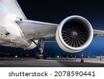 Small photo of Powerful long-haul airliner jet engine isolated at night. Together with the well lit landing gear, this makes a nice aviation wallpaper