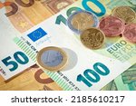 EU euro coins on heap of euro bills. EU economy and finance. Cash money. Currency background. Close up view.