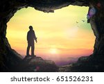 International migrants day concept: Silhouette humble man standing on cave autumn sunset background