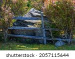 Small photo of Wooden fence in front of a large boulder at Grayson Highlands State Park in Virgina's Highlands near Mount Rogers and White top Mountains.