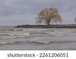 Small photo of Lake Erie on a blustery winter day pushing waves ashore and flurries of snow under stormy skies at Edgewater Park in Cleveland, Ohio.
