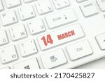 March 14th. Day 14 of month, Calendar date. Cropped view of Modern White Computer Keyboard with calendar date. Concept workspace, freelance, deadline.  Spring month, day of the year concept