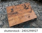 Small photo of Thermopylae, Greece - September 26th, 2022: Epigram, which is engraved as an epitaph on a commemorative stone placed on top of the burial mound of the Spartans. Selected focus.