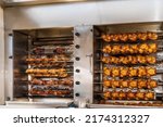 Small photo of Grilling chickens on a rotisserie