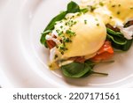 Small photo of Luxury breakfast, brunch and food recipe, poached eggs with salmon and greens on gluten-free toast for restaurant menu and gastronomy branding