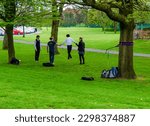 Small photo of Botanic Gardens Belfast Northern Ireland, April 28 2023 - People practicing tightrope walking in Botanic Gardens in Belfast County Down