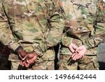 Hands, arms of African American and Caucasian US army troops giving tribute to American soldiers died for Czech Republic country liberation
