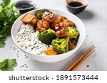 Asian vegan bowl with rice, broccoli and fried tofu