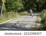 Small photo of Woman swerving on her bicycle on the North Branch Trail in Morton Grove, Illinois