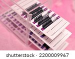 Small photo of Mink lashes for eyelash extensions on pink background,beauty equipment . High quality photo