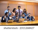 Small photo of Indian businesspeople and employee giving happy expression after looking in laptop at office.
