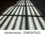 Small photo of SINGAPORE - 24 OCT 2023: 11am. A GRID of light and shadows from a translucent skylight in a building. A grid is a network of lines that cross each other to form a series of squares or rectangles.