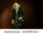Small photo of Ghost of Jacob Marley, Scrooge ex-business partner, chained with a padlock, carrying treasure chests and keys