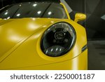 Small photo of Dubai, United Arab Emirates - January 16th, 2023 - Photo of a yellow matt ppf car with headlight