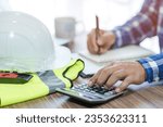 Small photo of revenue calculation engineer construction costs on the desk concept of capital analysis Recurring income and expenditure selective focus