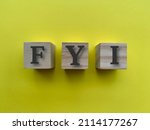 Small photo of Alphabets of FYI on wooden blocks with yellow background.