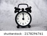 Small photo of Alarm clock pointing at 12 o'clock with customizable space for ideas or text. Copy space and time concept
