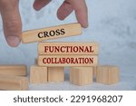 Hand placing wooden blocks with cross functional collaboration text on wooden blocks. Operational excellence and business concept.