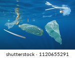 Plastic ocean pollution. Underwater bags, bottles, cups, straws    