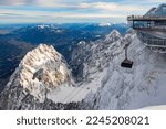 Cable car reaching the modern mountain station “Zugspitze“ (2962 m) on highest peak of Germany and part of the “Wetterstein“ alpine range near Garmisch-Partenkirchen in winter. Panoramic view.
