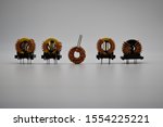 Small photo of Coils with magnetic core and copper winding isolated on white background. Magnetic Inductors Ferrite Core Common-Mode EMI Suppression. Choke coil used for EMC Test. Toroidal Coil Inductor.