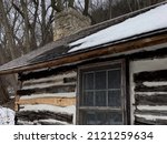 Small photo of DUBUQUE, IOWA, February 6, 2022–Landscape photo of log cabin taken at historic Mathias Ham House landmark site on overcast winter day.