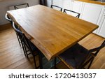 A Big Wooden Dining Table With...