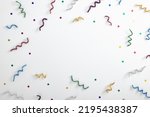 Small photo of Tinsel on white background. Party pattern with glitter, stars and tinsel. Copy space with party elements. Tinsel for christmas party. Xmas pattern on white background with text space