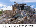 Small photo of Landscape of ruined buildings, image of decrepitude or natural disaster. The house is destroyed. Destruction of old houses, earthquakes, economic crisis, abandoned houses. Broken unfit house