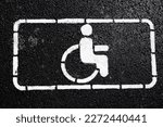 Handicap symbol on road. Road marking on the asphalt with parking spaces for the disabled. wheelchair symbol of disabled parking lot for handicapped person on concrete road
