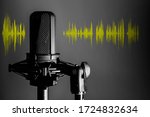 Small photo of Professional microphone with yellow voice waveform on dark background, sound studio recording