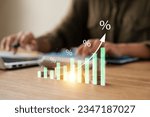 Small photo of Interest rate and dividend concept, Businesswoman calculates investment returns with percentage symbol and up arrow, return on stocks and mutual funds, long term investment for retirement.