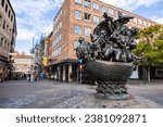 Small photo of Nuremberg, Germany - October 25, 2023: Ship of Fools sculpture just north of Museums bridge. Bronze ship filled with characters that are sailing in a world of doom. Representation of Durer woodcuts