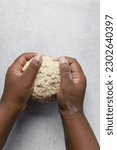 Small photo of Hand kneading bread dough on a marble surface, female hands kneading sticky dough, high hydration dough being kneaded on marble table