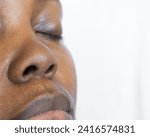 Small photo of Brown skin woman with a button nose, selective focus on a small nose, black woman with a snub nose
