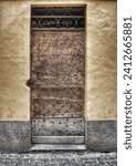 Small photo of Image of a single door dating back to the 19th century or earlier, photographed in a medieval village in the Ligurian hinterland, Italy.