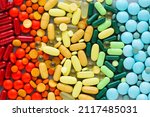 Assorted rainbow colorful tablets, pills, drugs background. Medication and healthcare concept. Close up, top view