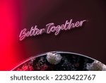 BETTER TOGETHER inscription in neon lights at night. Electric sign at night nightlife concept. Modern fluorescent life style luminescent. LED light sign text 