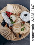 Small photo of Correct serving of cheese plate , cheeses lie clockwise. Exquisite lunch, festive dinner . Enjoying taste. Menu for holidays, weddings, parties. Slicing technique for different types of cheese.