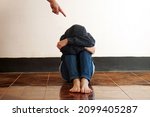 Small photo of A finger point to a guilty feeling boy sit on the floor. Concept : Intimidation or stick discipline strategy to control or punish kid behavior that affect to mental in childhood. Psychology.