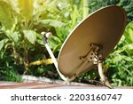 Small photo of Vintage satellite receiver dish on the roof in rural house. Concept : Terrestrial TV receivers. TV antenna. Device technology for receiving television broadcasting