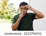 Small photo of Asian man stands outdoor, feel dizzy and faint, smells inhaler to relieve. Concept : health problem, sickness and remedy. Increases freshness, reduces dizziness and stuffy nose. self take care.