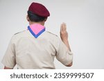 Small photo of Back view of scout shows hand sign. Concept, Scout activity that teaching in schools Thailand. Hand signs and symbols which meaningful in scouting lesson. Show hand sign for oath.