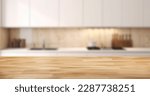 Small photo of Empty beautiful wood table top counter and blur bokeh modern kitchen interior background in clean and bright, Ready,white background, for product montage