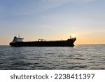 Small photo of Crude oil tanker in the sea at sunset.